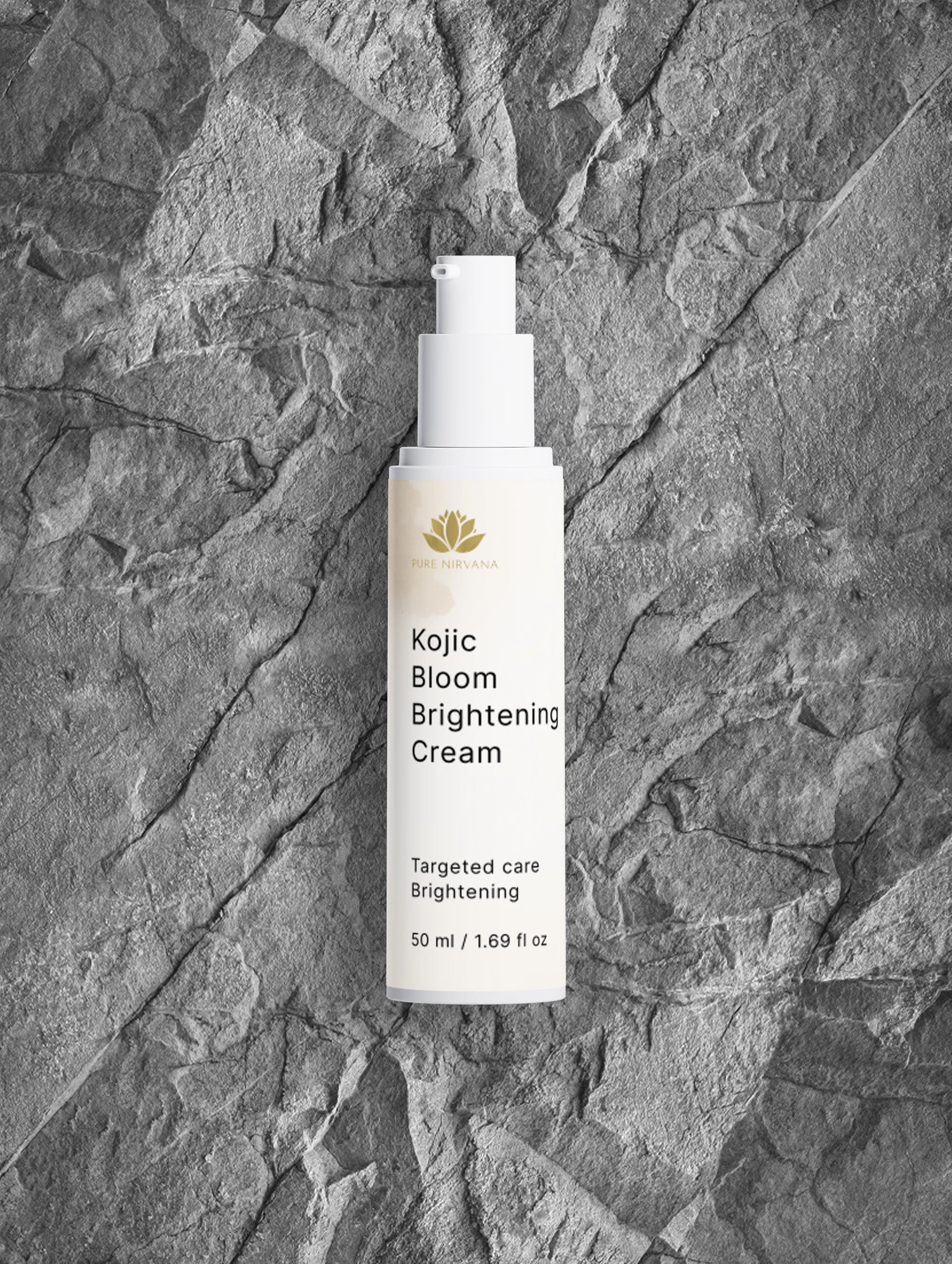 A white pump bottle of Kojic Bloom Brightening Cream with a gold lotus logo, centered on a textured gray stone background.