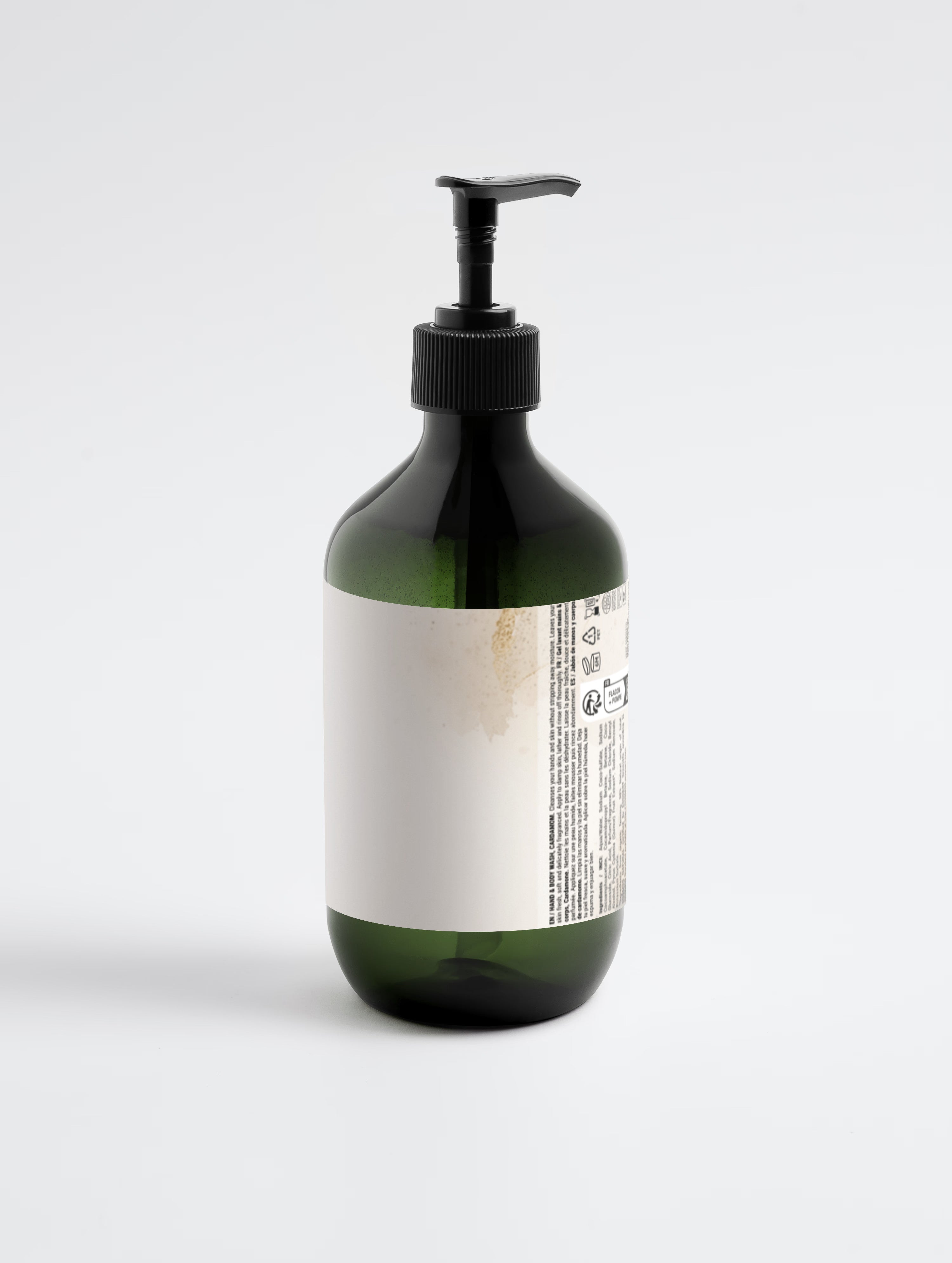 Green bottle with pump on a white background