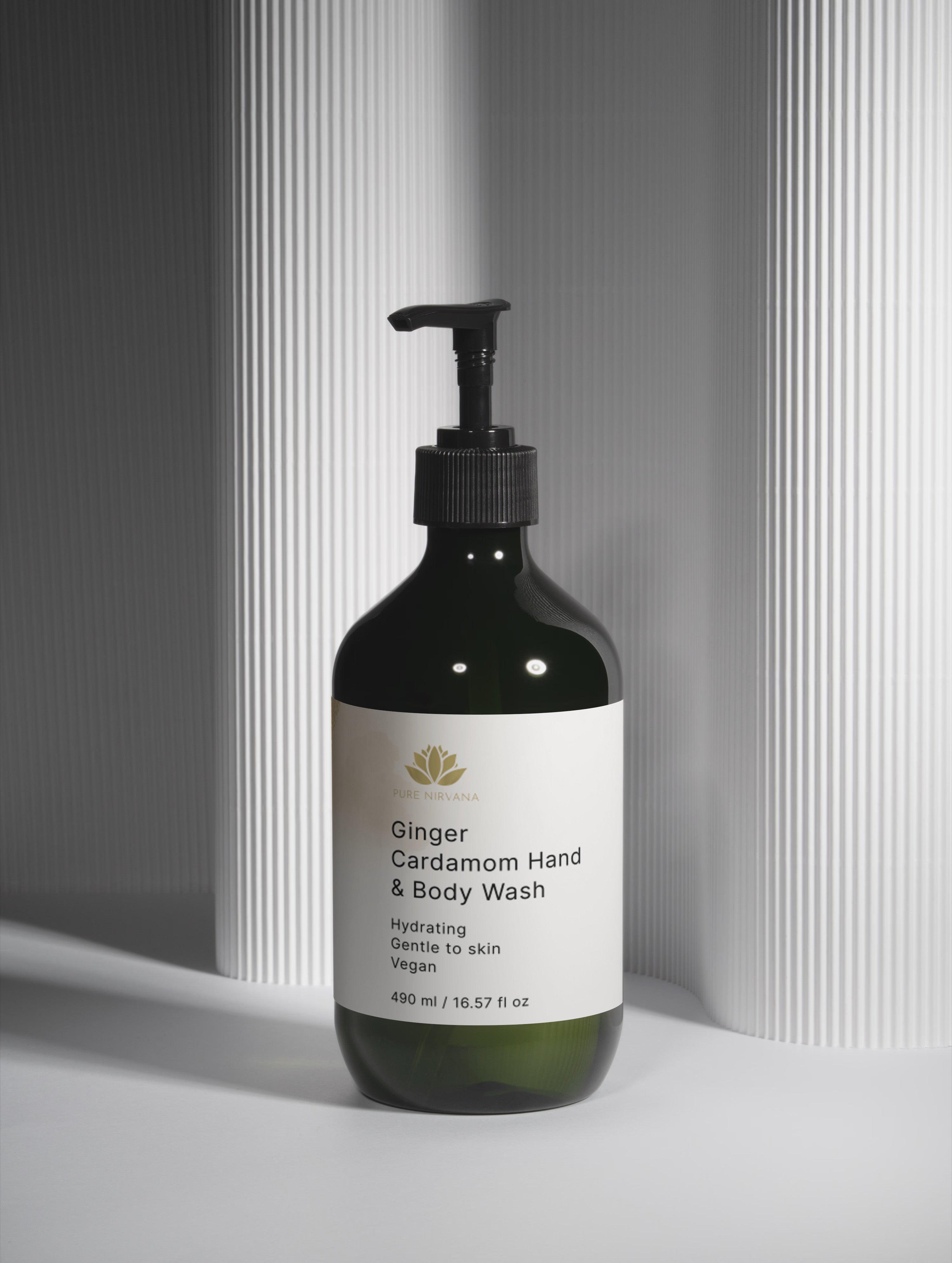Hand and body wash bottle with a label on a neutral background